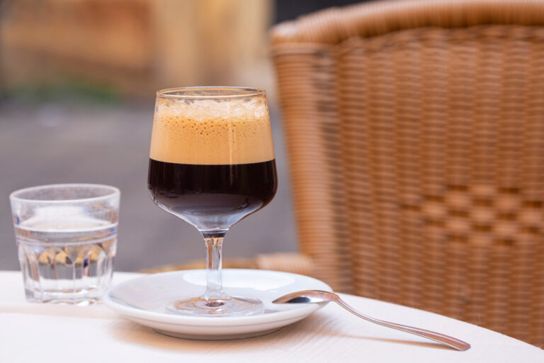 Caffe shakerato coffee in a tall glass at italian cafe