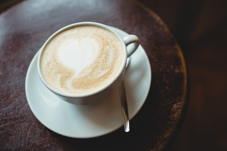 White Coffee: The Definition and Meaning Fresh coffee with milk served on table at cafe