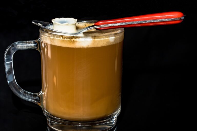 cafe au lait in glass mug with spoon