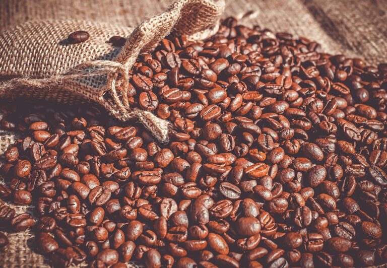 coffee beans flowin out of a burlap sack