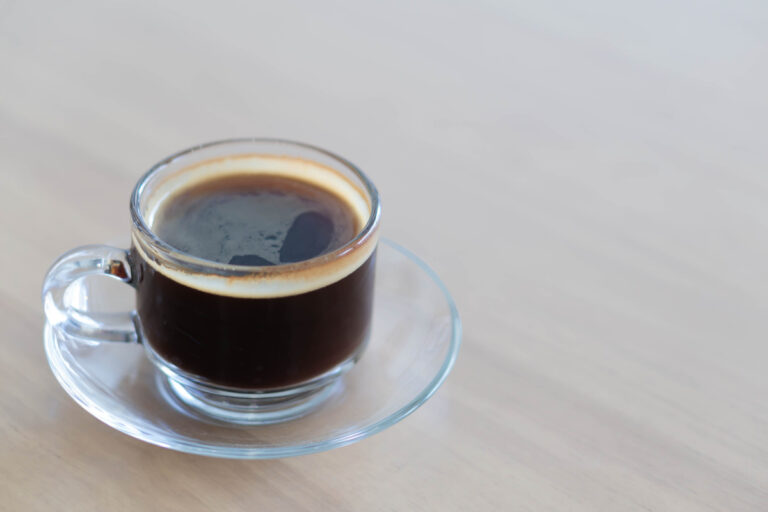 hot Americano coffee on wood table