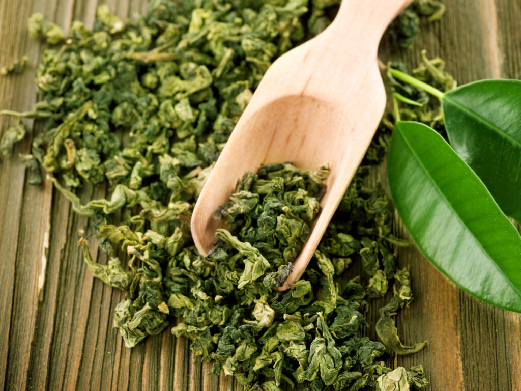green tea with wooden scoop