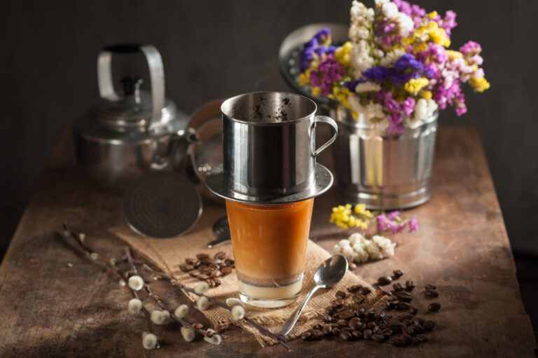 Vietnamese drip coffee with condensed milk and low light scene