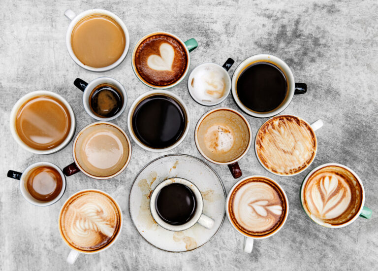 Assorted coffee cups on a textured background