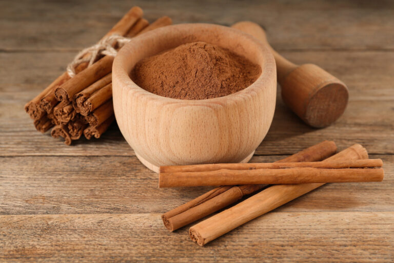 Cinnamon: The Definition and Meaning cinnamon powder and sticks with mortar and pestle