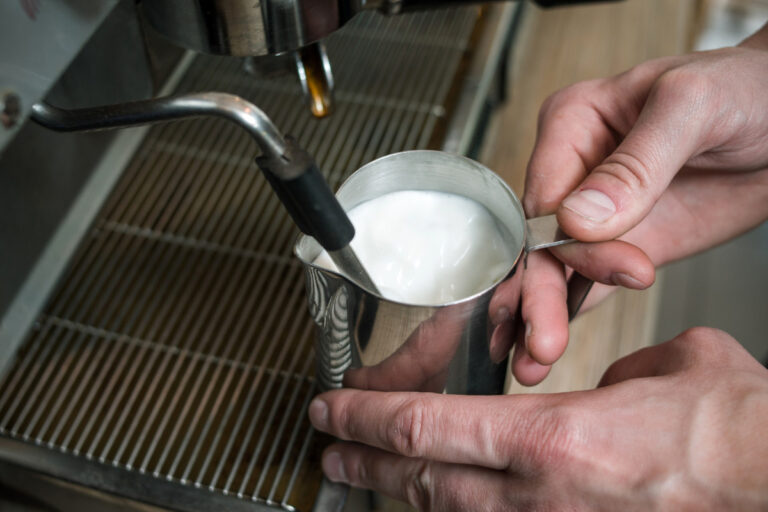Steam Wand: The Definition and Meaning a barista steaming milk with a steam wand