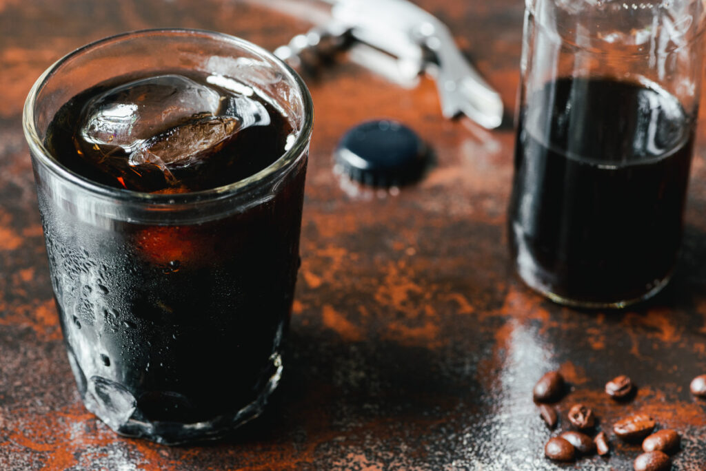 cold brew coffee with ice in glass and bottle