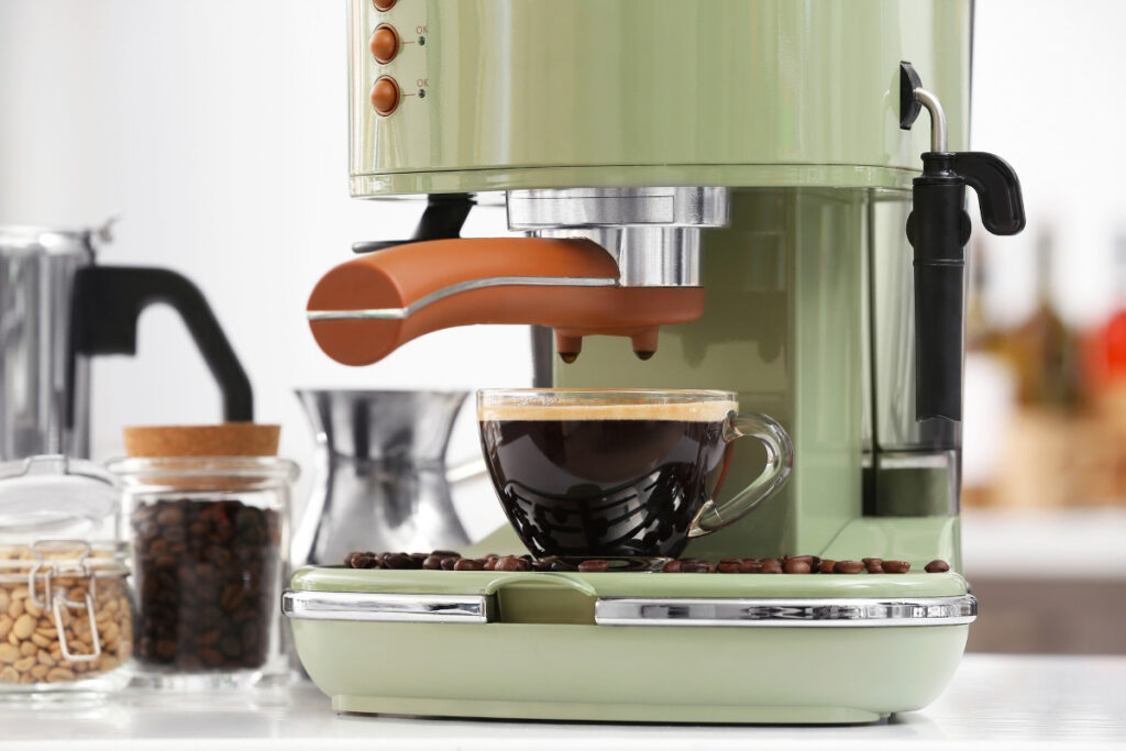 espresso machine with cup of fresh coffee on table